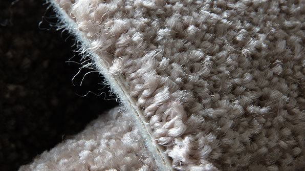 a close view of structure of tufted wall-to-wall carpet